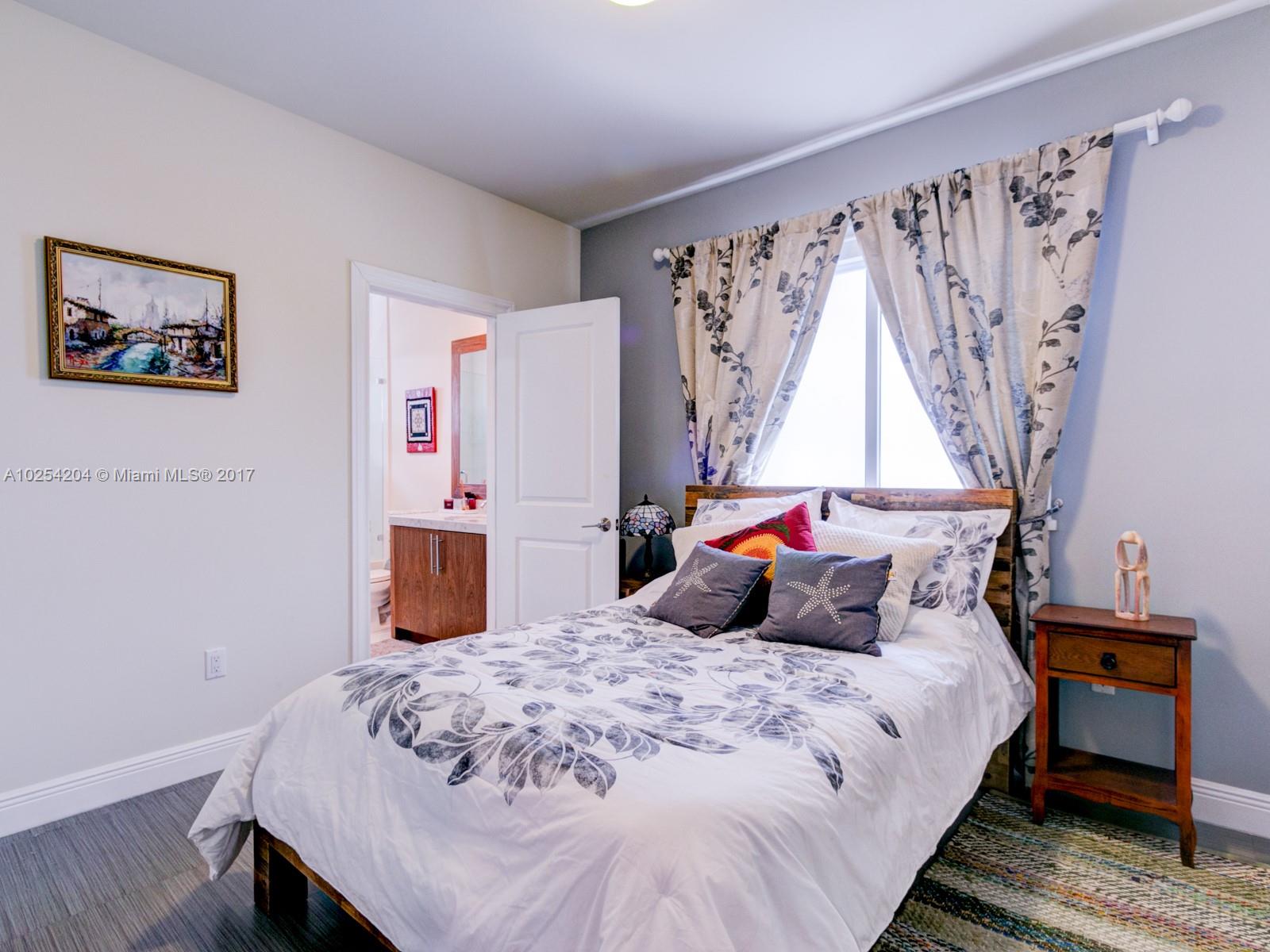 2993 Ruth Street, Unit 2993 Coconut Grove, FL 33133 - Photo 24 of 29 a bedroom with a bed and a window