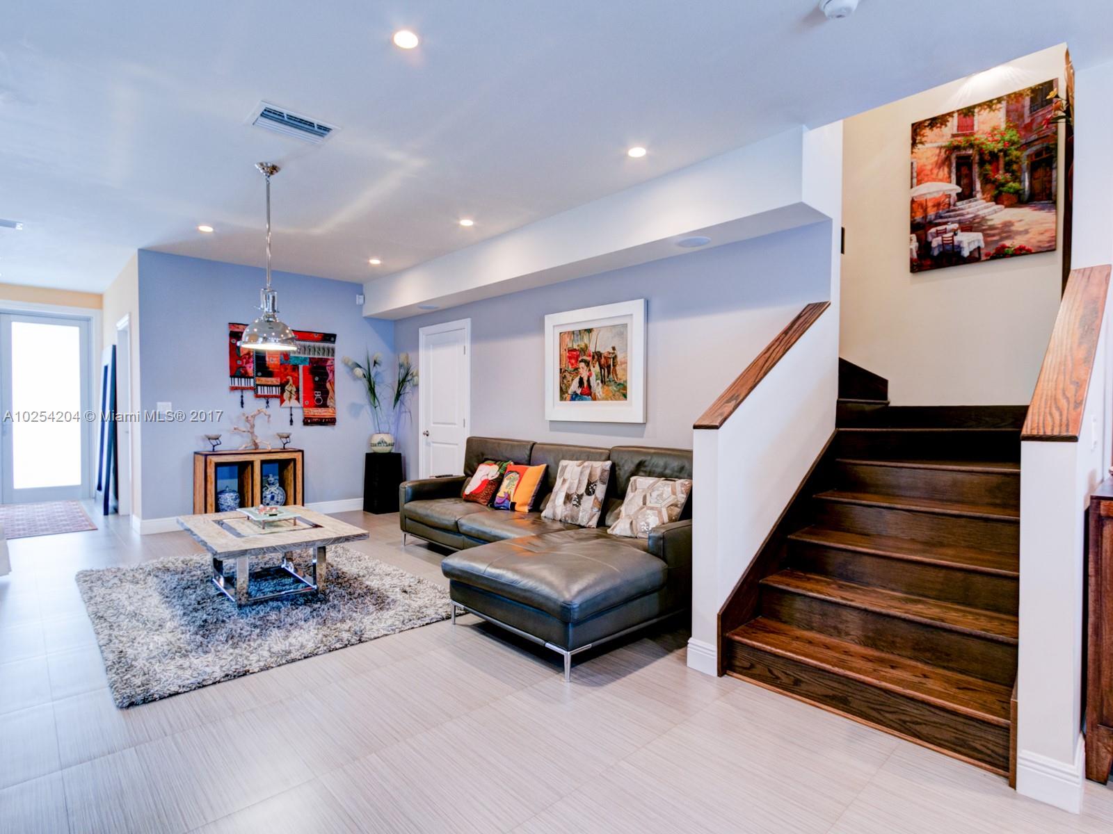 2993 Ruth Street, Unit 2993 Coconut Grove, FL 33133 - Photo 6 of 29 a living room with furniture and a book shelf