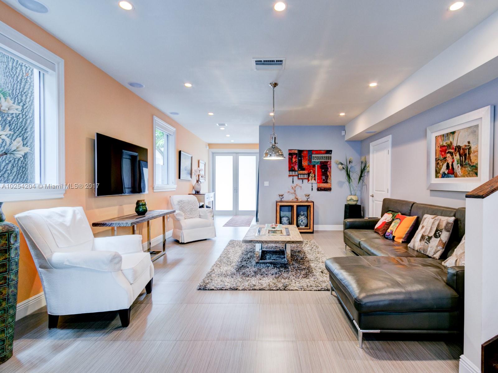 2993 Ruth Street, Unit 2993 Coconut Grove, FL 33133 - Photo 8 of 29 a living room with furniture and a flat screen tv