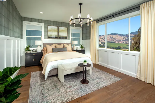 a bed sitting in a spacious bedroom next to a window