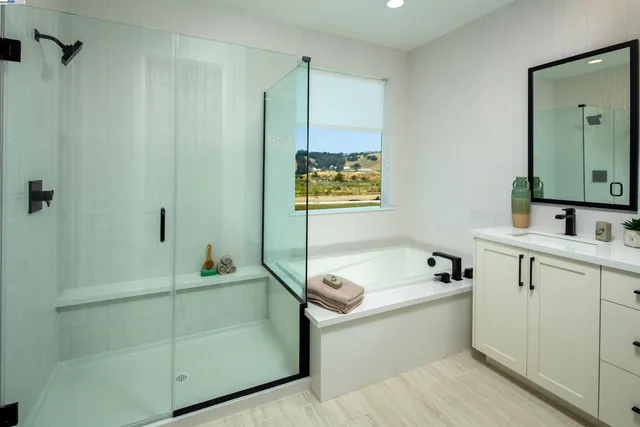 a bathroom with a tub sink and mirror