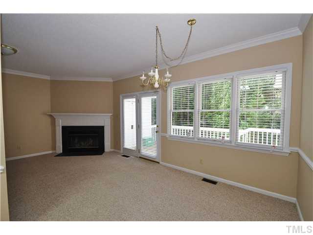3705 Carnegie Lane Raleigh, NC 27612 - Photo 16 of 17 a view of an empty room with a fireplace and a window