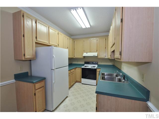3705 Carnegie Lane Raleigh, NC 27612 - Photo 2 of 17 a kitchen with stainless steel appliances granite countertop a refrigerator sink and cabinets