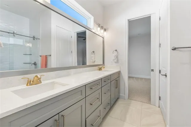 a spacious bathroom with a shower sink and mirror
