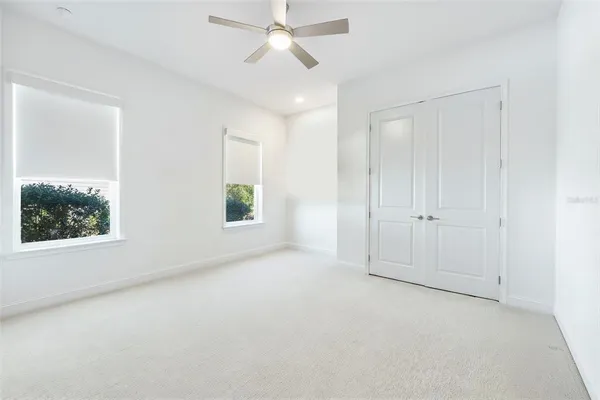 an empty room with windows and closet