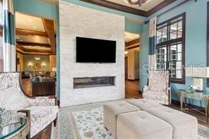a living room with furniture a fireplace and a flat screen tv