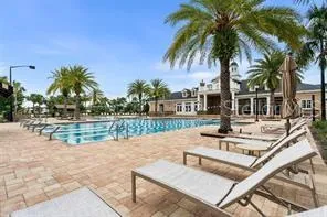 a view of house with outdoor space and swimming pool