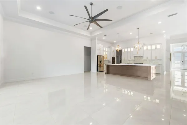 a view of a kitchen with a sink and a refrigerator