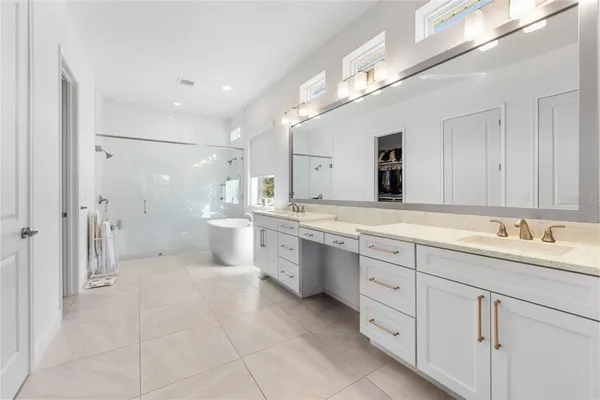 a large bathroom with a granite countertop sink mirror and a