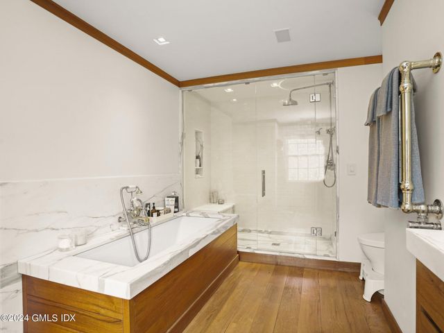 a bathroom with a tub sink and mirror