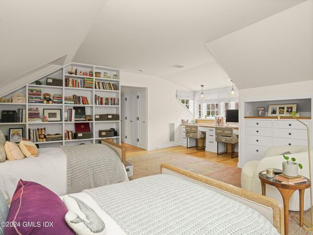 a bedroom with a bed and a chair