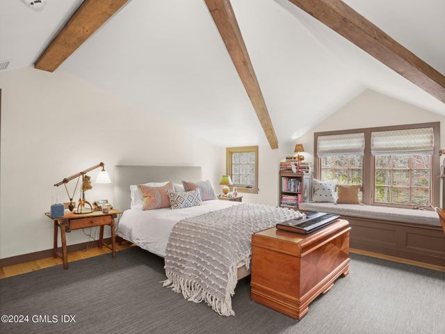 a spacious bedroom with a bed and a large window