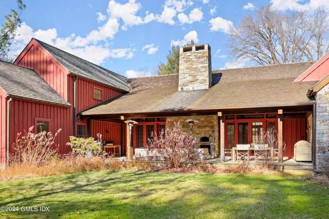 a front view of house with yard patio and fire pit