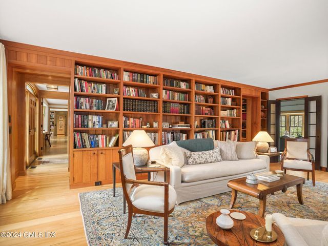 a living room with furniture and a book shelf