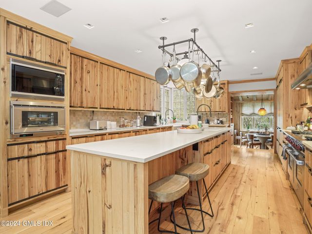 a kitchen with stainless steel appliances a stove a sink and a refrigerator