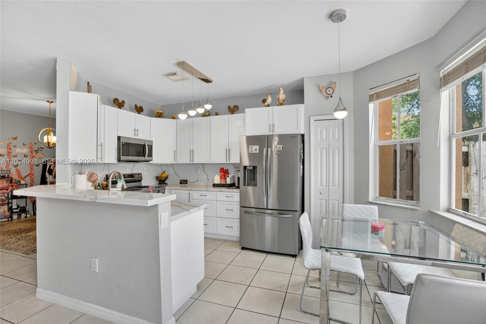 16651 Southwest 79th Terrace Miami, FL 33193 - Photo 11 of 34 a kitchen with cabinets and stainless steel appliances