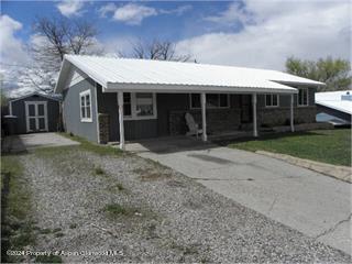 525 East 12th Street Rifle, CO 81650 - Photo 1 of 26 a front view of a house with a garden