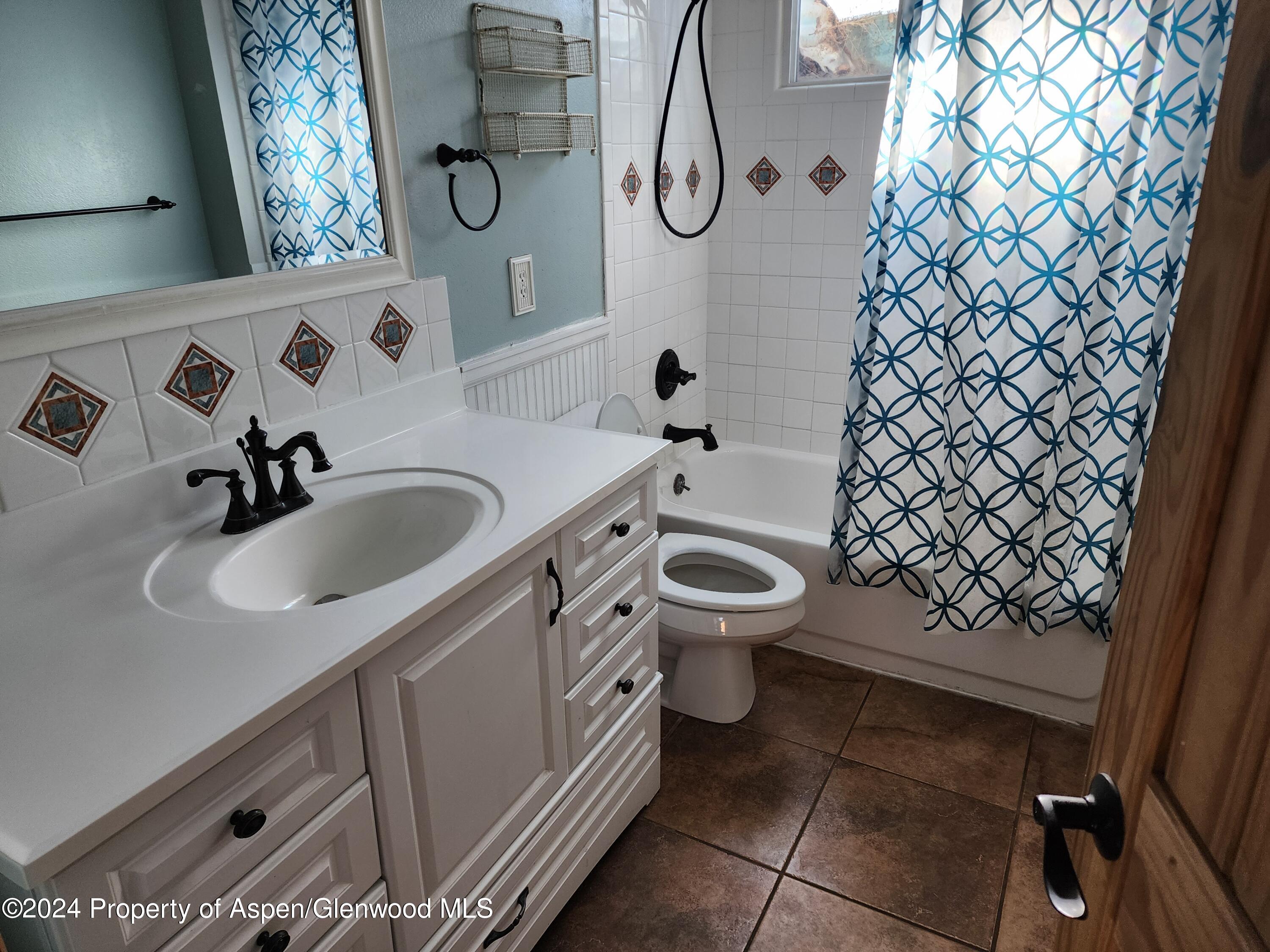 525 East 12th Street Rifle, CO 81650 - Photo 13 of 26 a bathroom with a sink and mirror with toilet