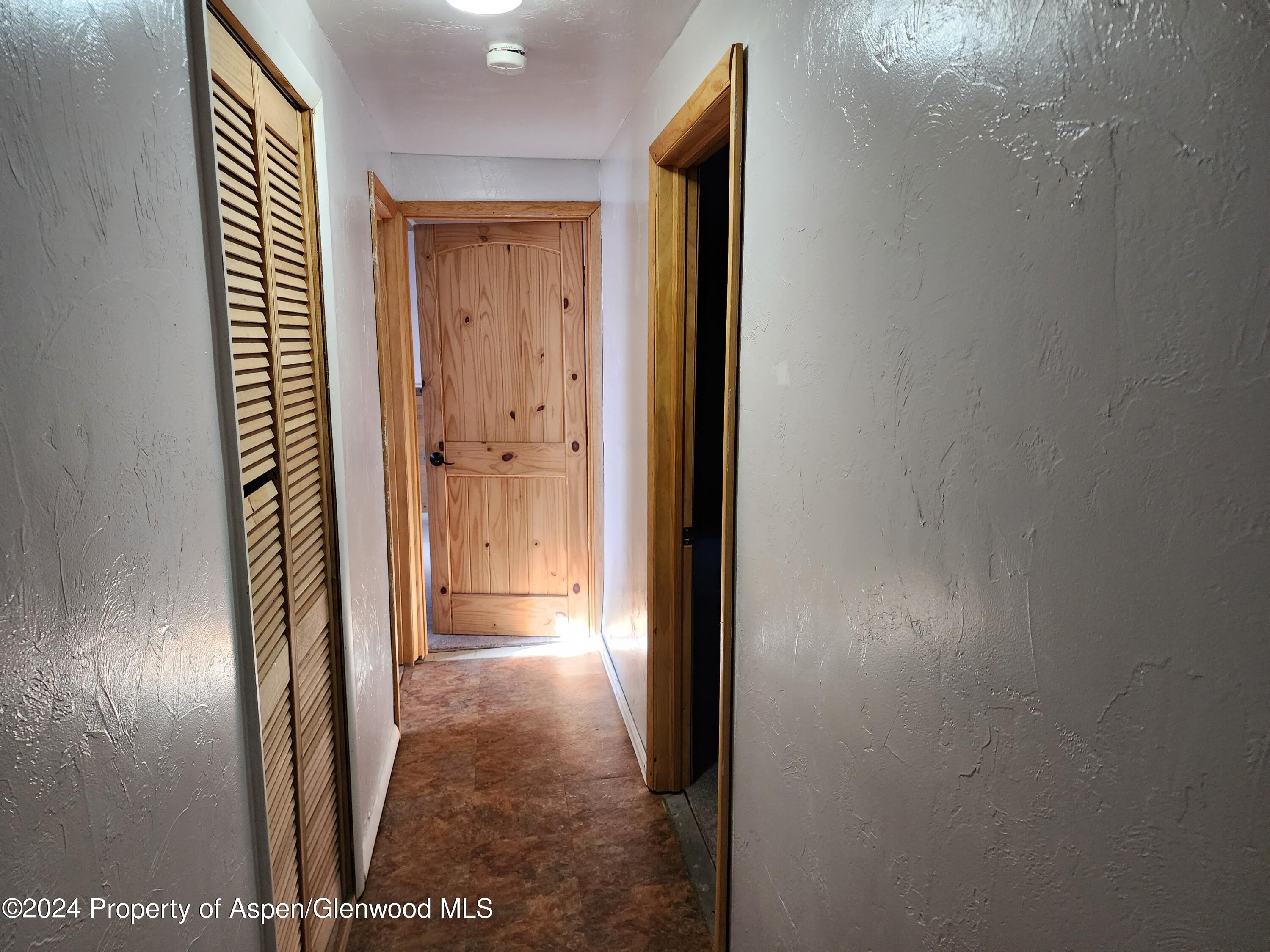 525 East 12th Street Rifle, CO 81650 - Photo 14 of 26 a view of a hallway with wooden floor