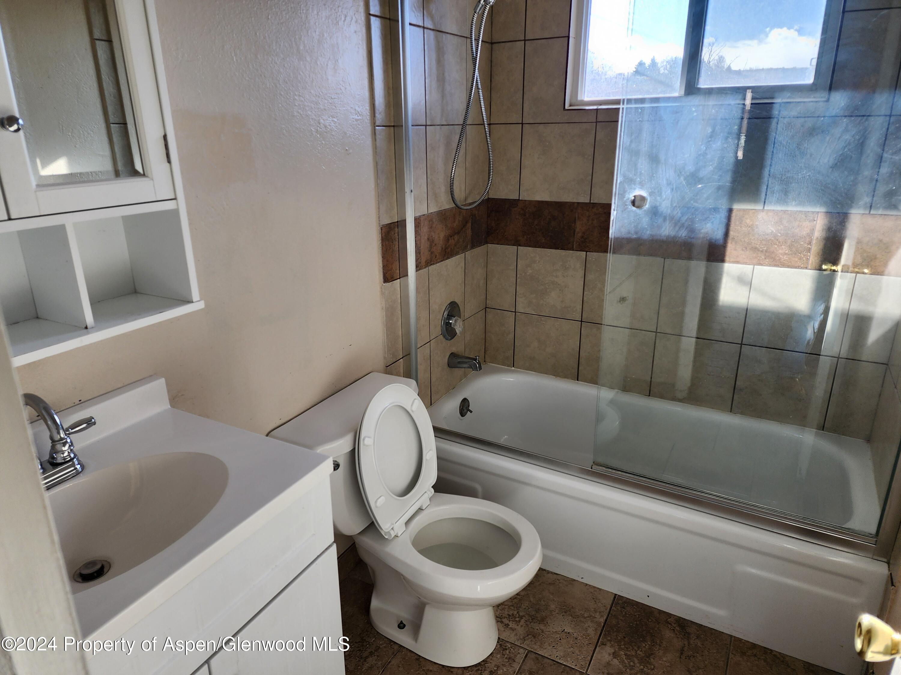 525 East 12th Street Rifle, CO 81650 - Photo 18 of 26 a bathroom with a toilet and a bathtub
