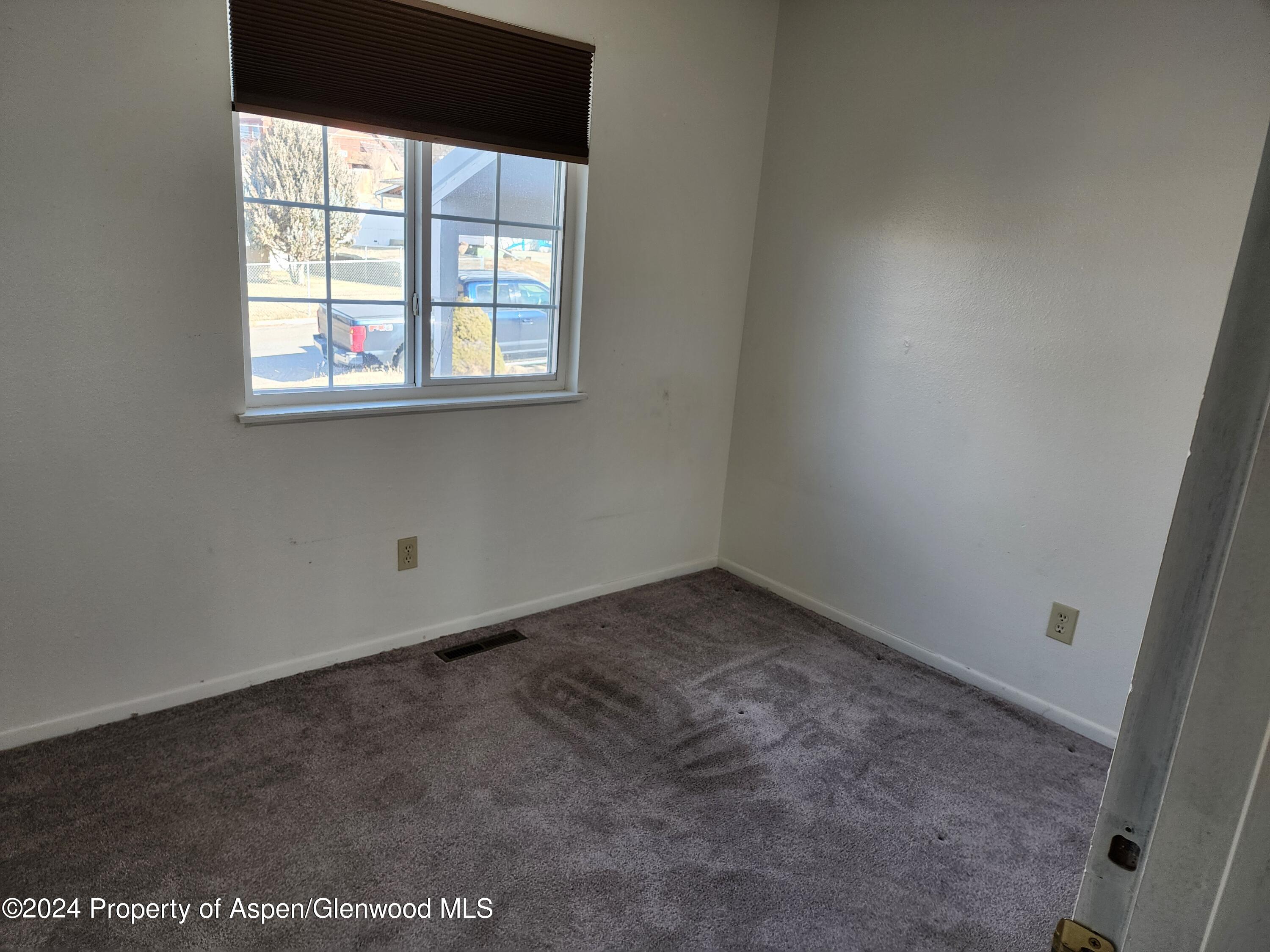 525 East 12th Street Rifle, CO 81650 - Photo 20 of 26 an empty room with a window