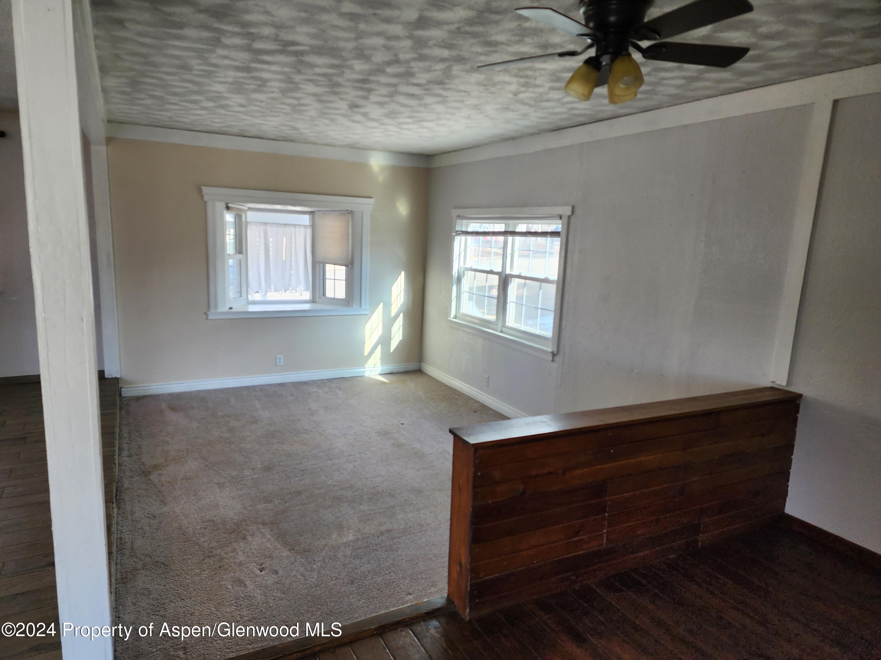 525 East 12th Street Rifle, CO 81650 - Photo 21 of 26 a room with wooden floor and windows