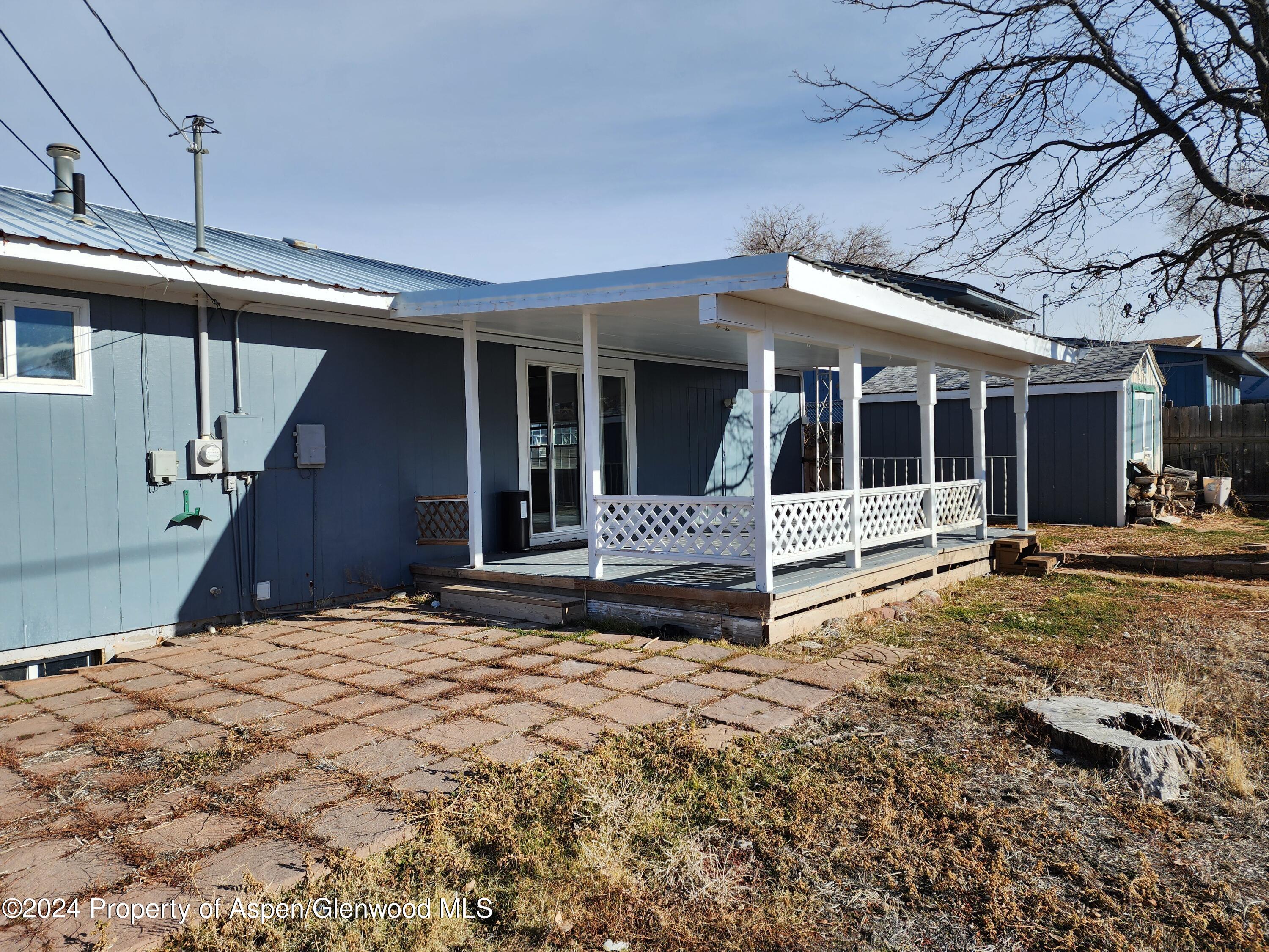 525 East 12th Street Rifle, CO 81650 - Photo 5 of 26 a view of a house with a large window and wooden fence