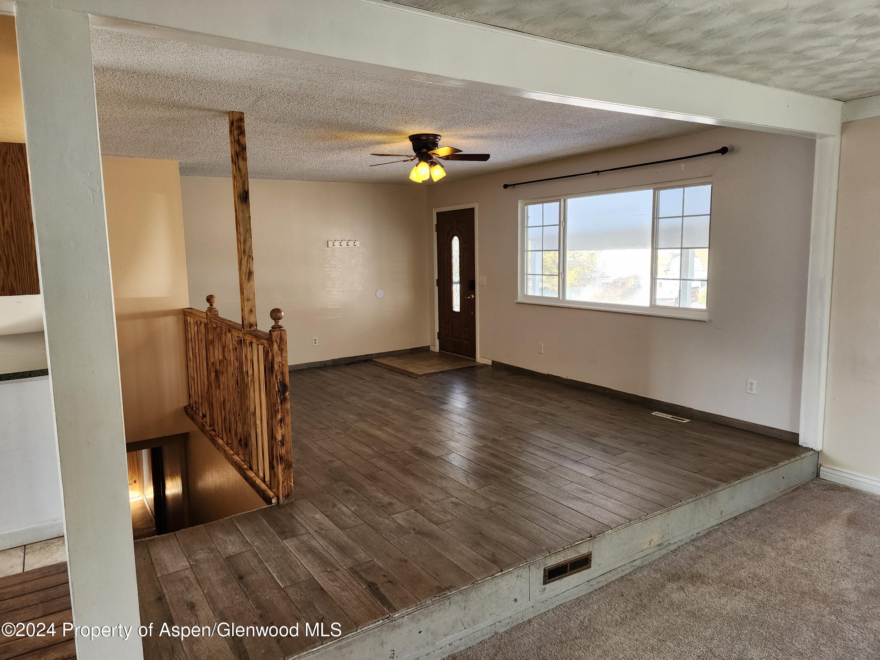 525 East 12th Street Rifle, CO 81650 - Photo 8 of 26 wooden floor in an empty room with a window