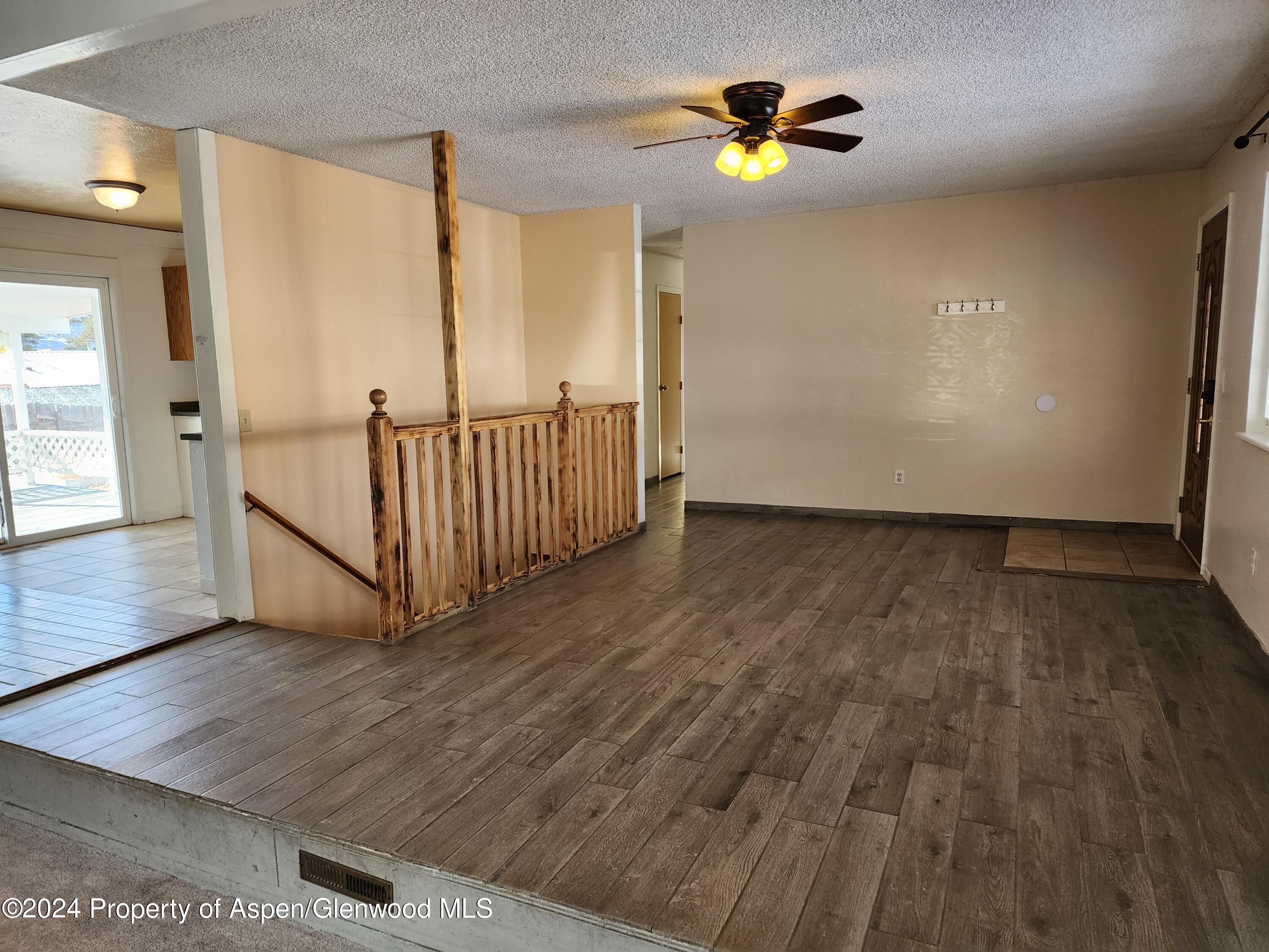 525 East 12th Street Rifle, CO 81650 - Photo 9 of 26 wooden floor in an empty room with a window
