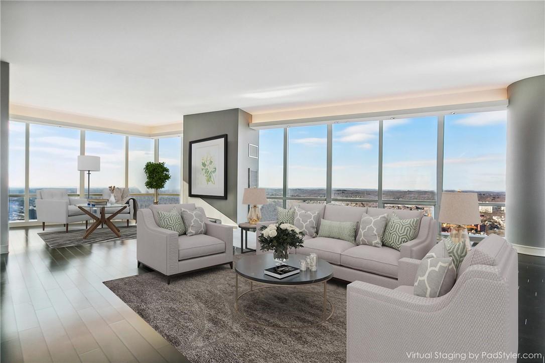 5 Renaissance Square, Unit PH40C White Plains, NY 10601 - Photo 1 of 1 a living room with furniture and a large window
