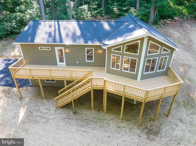a view of a house with a wooden deck