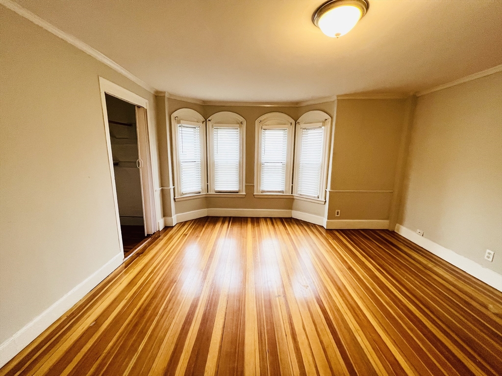 69 Adams Street, Unit 2 Boston, MA 02122 - Photo 1 of 5 a view of empty room with wooden floor
