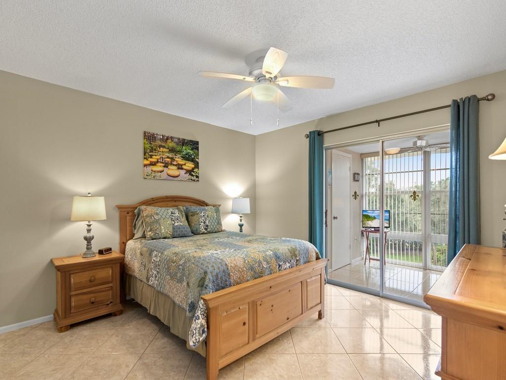 5400 Highway A1a, Unit I25 Vero Beach, FL 32963 - Photo 11 of 39 a bedroom with a bed and a chandelier
