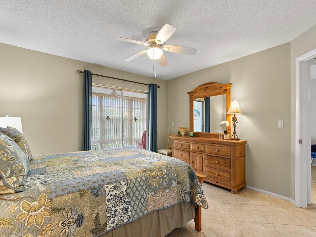 5400 Highway A1a, Unit I25 Vero Beach, FL 32963 - Photo 12 of 39 a bedroom with a large bed and a chandelier