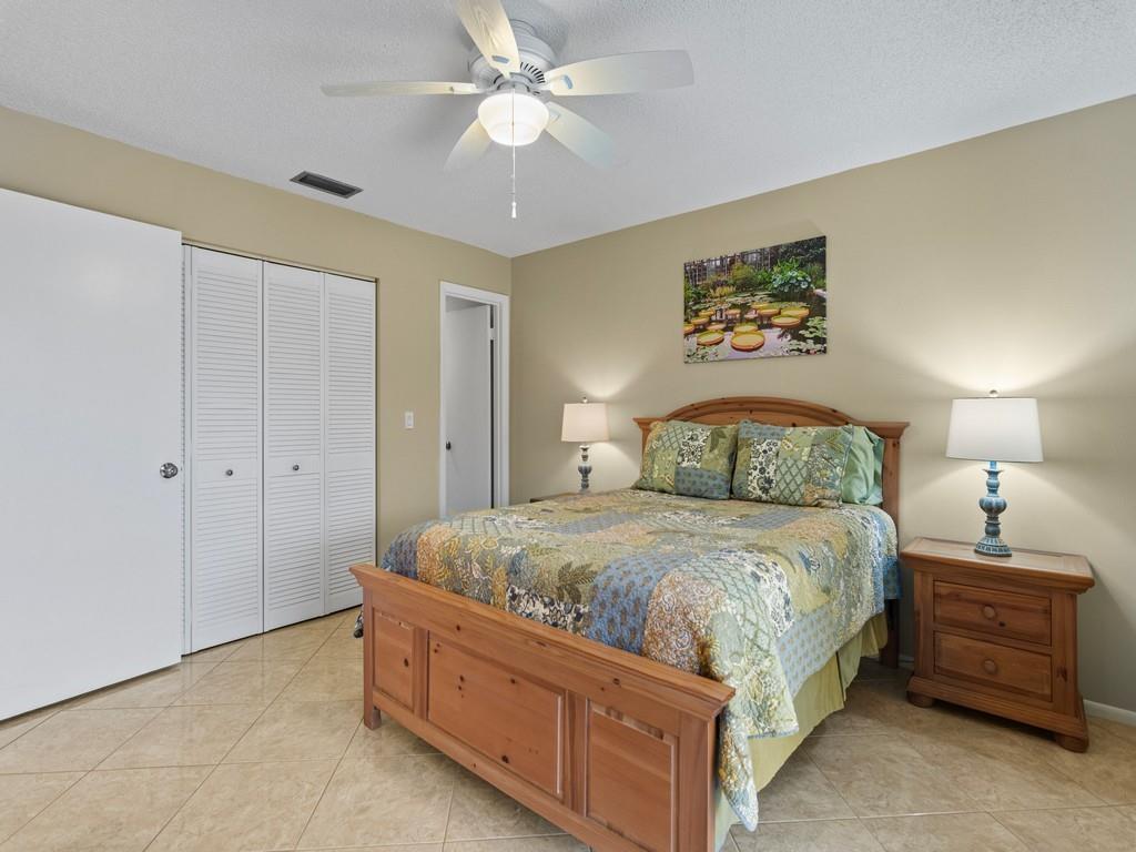 5400 Highway A1a, Unit I25 Vero Beach, FL 32963 - Photo 13 of 39 a bedroom with a bed and a chandelier