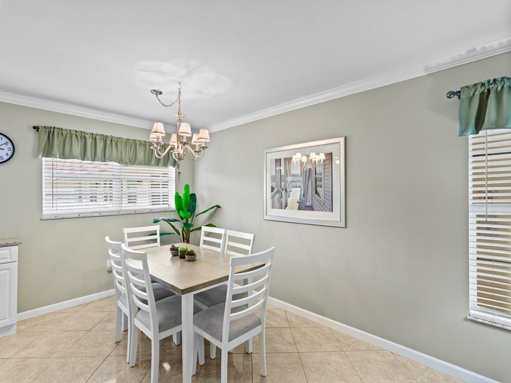 5400 Highway A1a, Unit I25 Vero Beach, FL 32963 - Photo 6 of 39 a dining room with furniture a chandelier and window