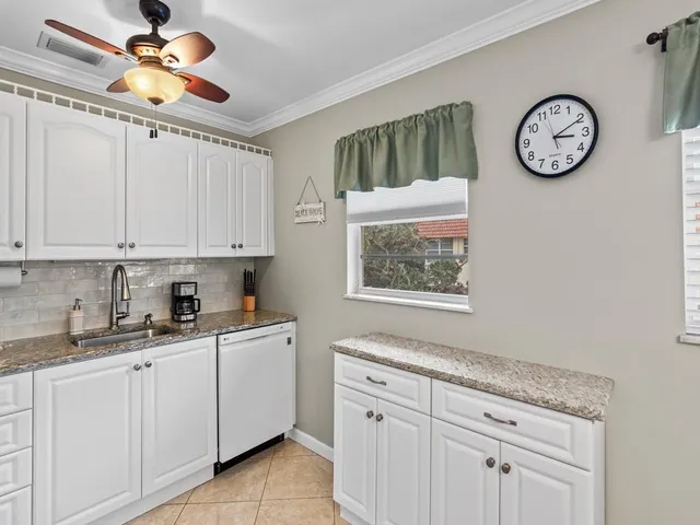 a kitchen with cabinets a clock and cabinets