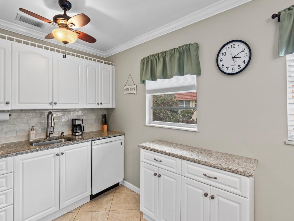 5400 Highway A1a, Unit I25 Vero Beach, FL 32963 - Photo 7 of 39 a kitchen with cabinets a clock and cabinets