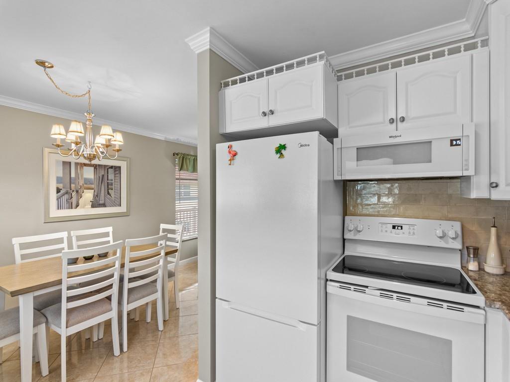 5400 Highway A1a, Unit I25 Vero Beach, FL 32963 - Photo 9 of 39 a white refrigerator freezer sitting inside of a kitchen