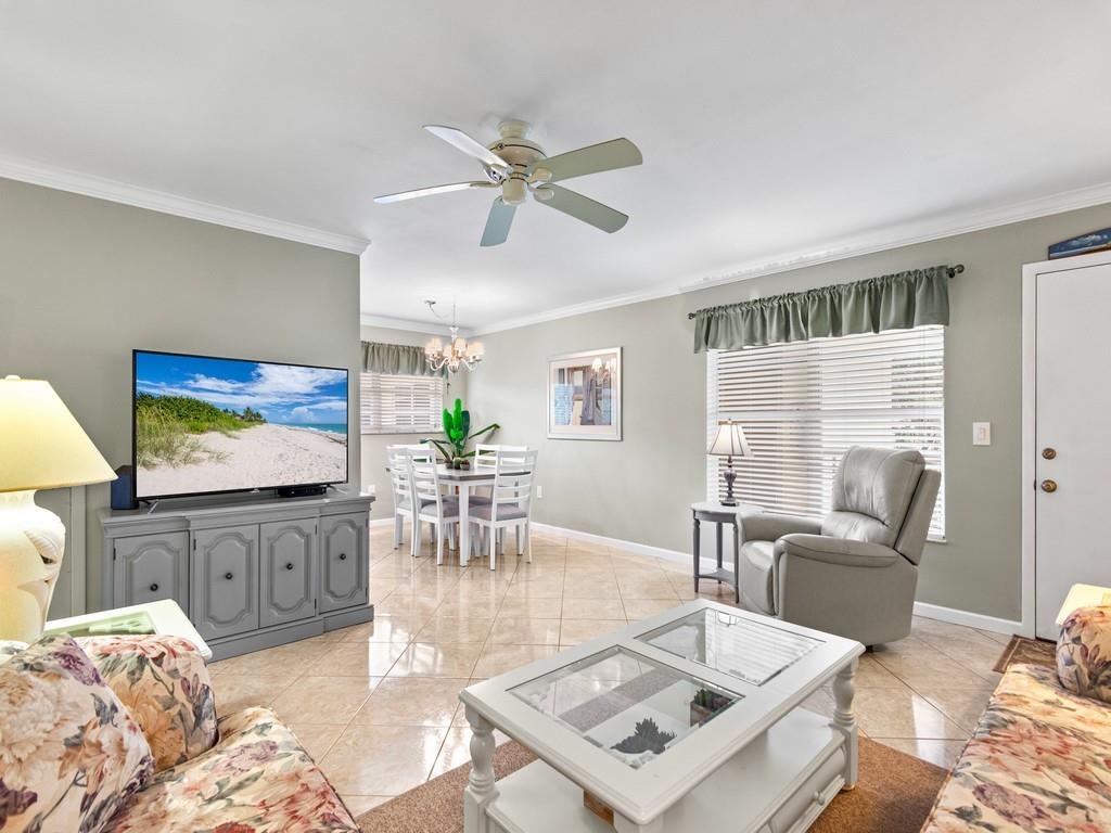 5400 Highway A1a, Unit I25 Vero Beach, FL 32963 - Photo 10 of 39 a living room with furniture a flat screen tv and a large window