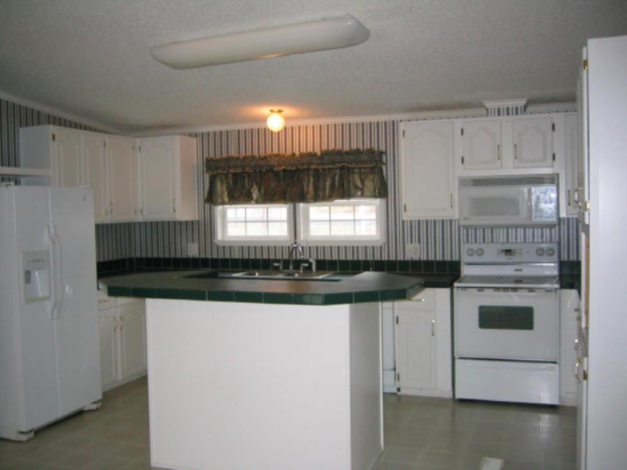 2560 Novelty Road Penhook, VA 24137 - Photo 3 of 5 a kitchen with granite countertop a sink and a stove top oven