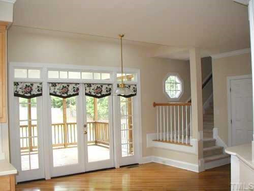 5212 Azure Lane Raleigh, NC 27613 - Photo 7 of 10 Bright Breakfast Room with skylights,built-ins, back stairs to bonus, 2 glass doors to screened porch. Service hall to right has coat closet, door to garage and 2nd pantry. Other
