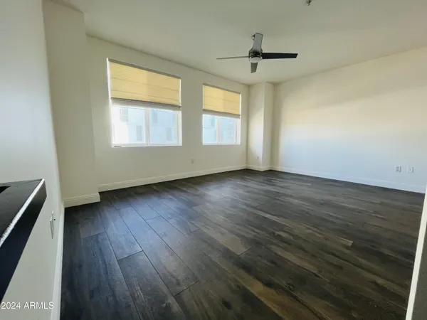 a view of a livingroom with wooden floor and stairs