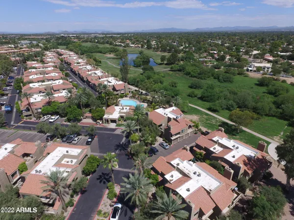 a view of a yard in front of the house with parked cars