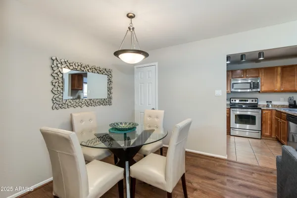 a kitchen with stainless steel appliances granite countertop a stove a sink dishwasher and cabinets with wooden floor