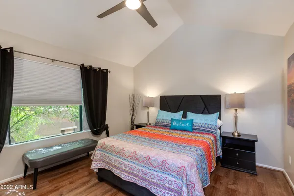 a bedroom with a bed and a flat screen tv