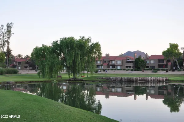 a view of lake with a house in the background