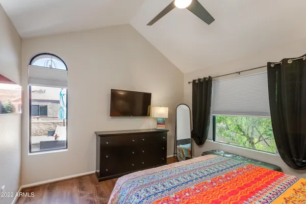 a bedroom with a bed and a flat screen tv