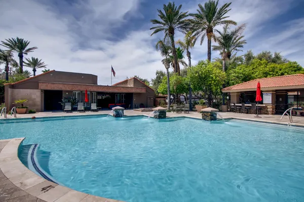 a view of a house with swimming pool and sitting area