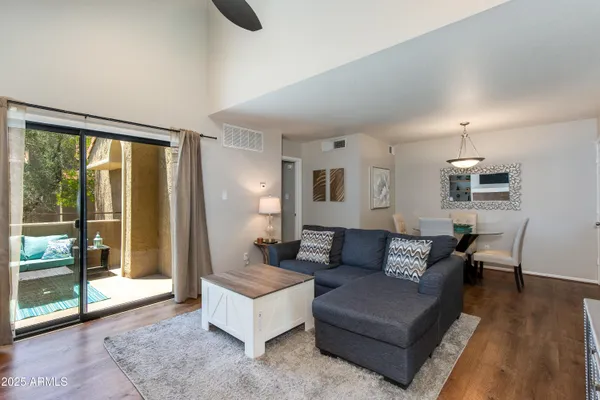 a living room with furniture and a floor to ceiling window